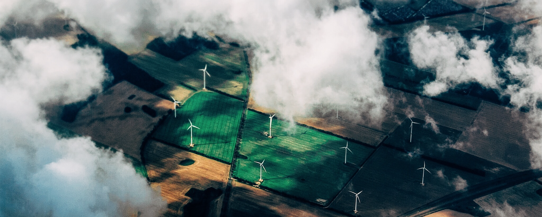 aerial photo of wind turbines near field