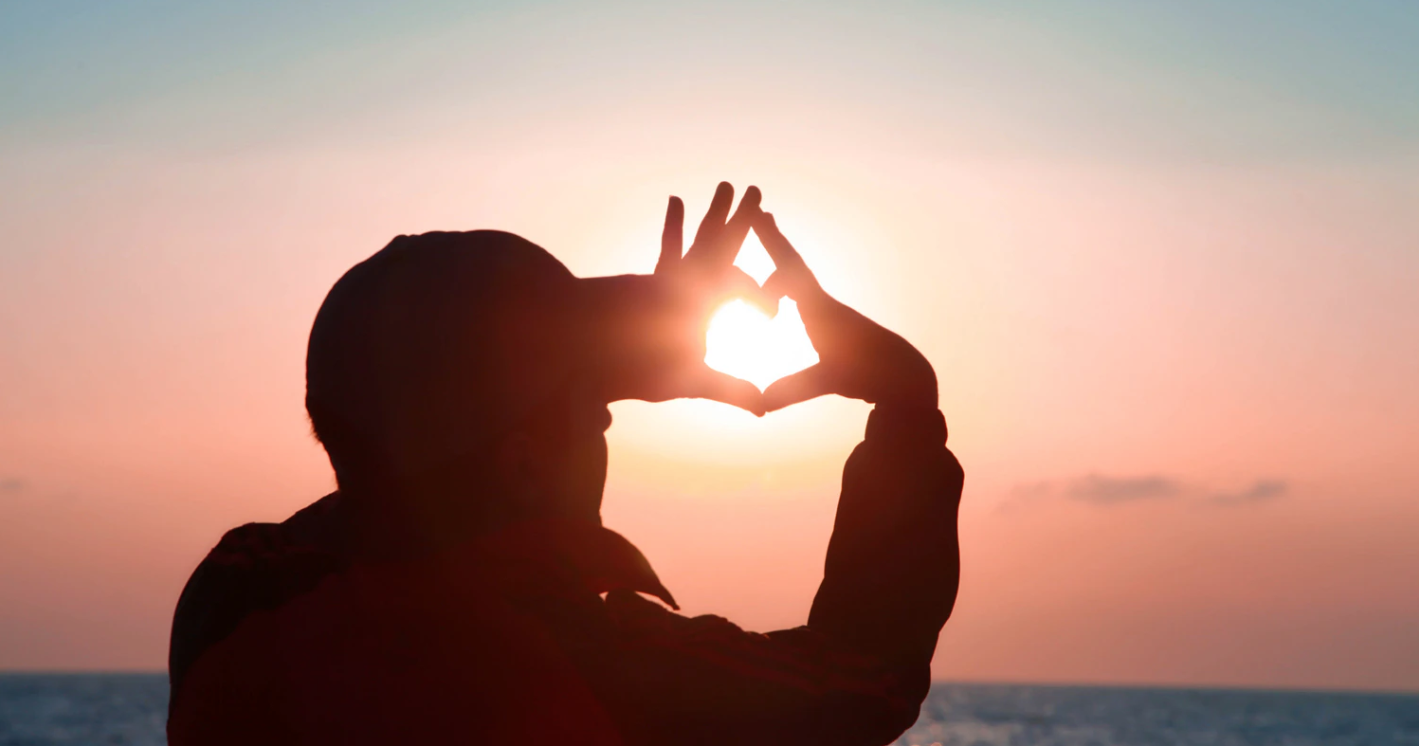 man catching the sun with his hands