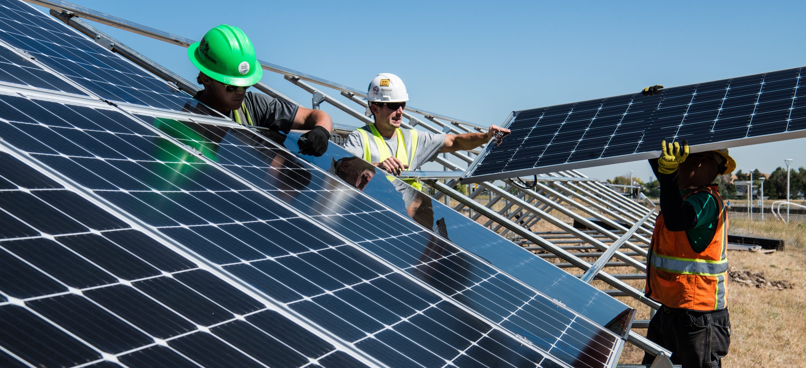 men at work with solar panels